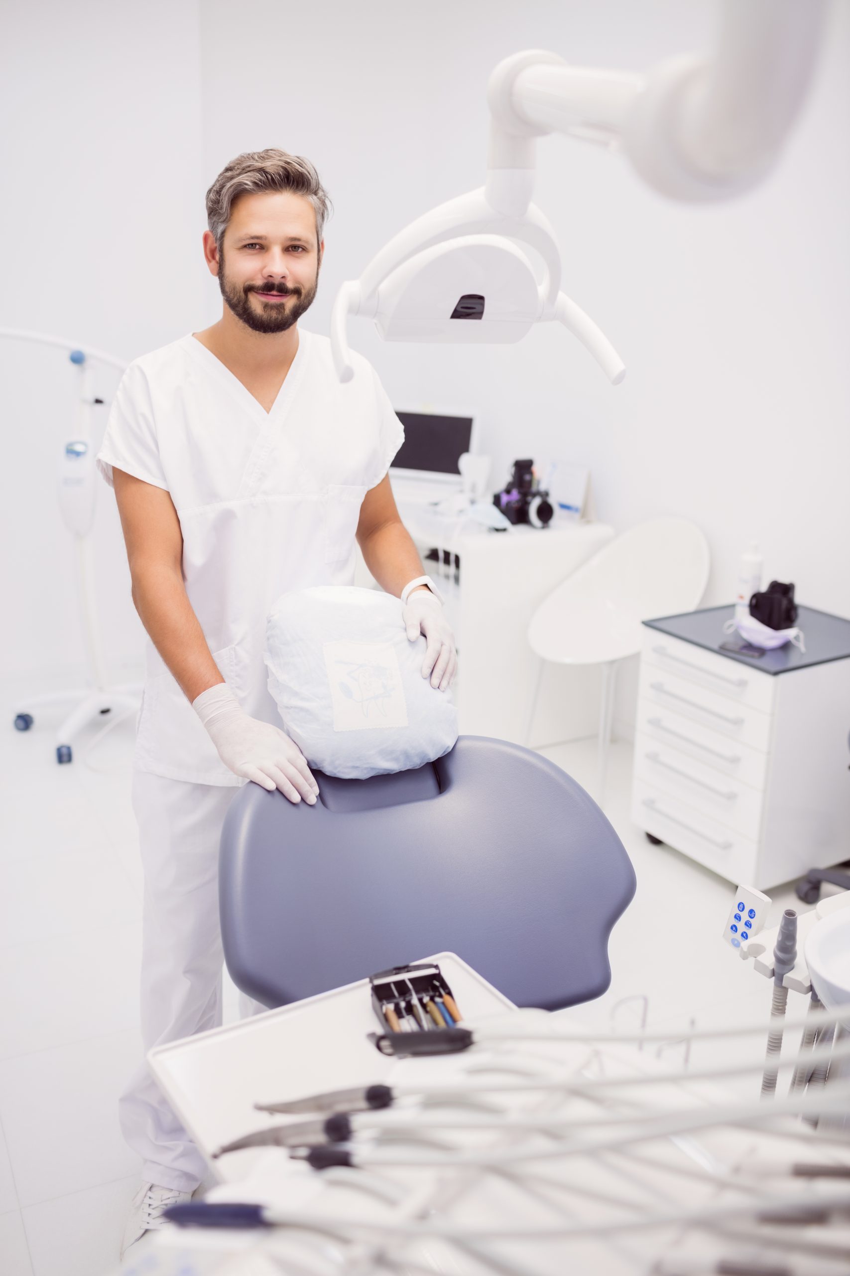 Portrait of dentist standing in clinic